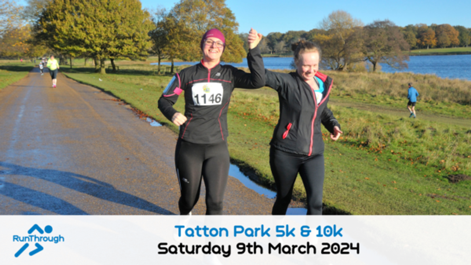Two smiling runners, one with a bib numbered 1146, hold hands and raise their arms in celebration during a Tatton Park 5k & 10k event. They run along a scenic path with a lake and trees in the background. Date mentioned: Saturday, 9th March 2024.