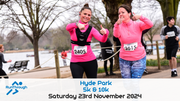 Two women in athletic gear, both wearing race bibs, give thumbs-up as they run through a park. The race bibs read 2405 and 2615. Other runners are visible in the background. The event, "Hyde Park 5k & 10k," is scheduled for Saturday, 23rd November 2024.