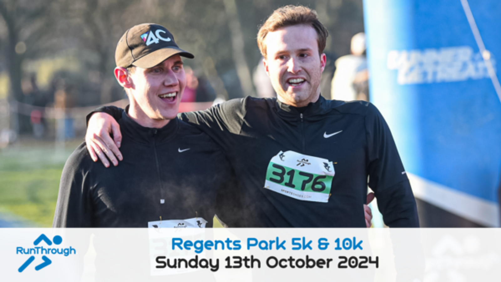 Two men, both wearing black athletic clothing and race bibs, celebrate as they cross the finish line of the Regents Park 5k & 10k event. One man has his arm around the other. A sign at the bottom reads "Regents Park 5k & 10k, Sunday 13th October 2024.