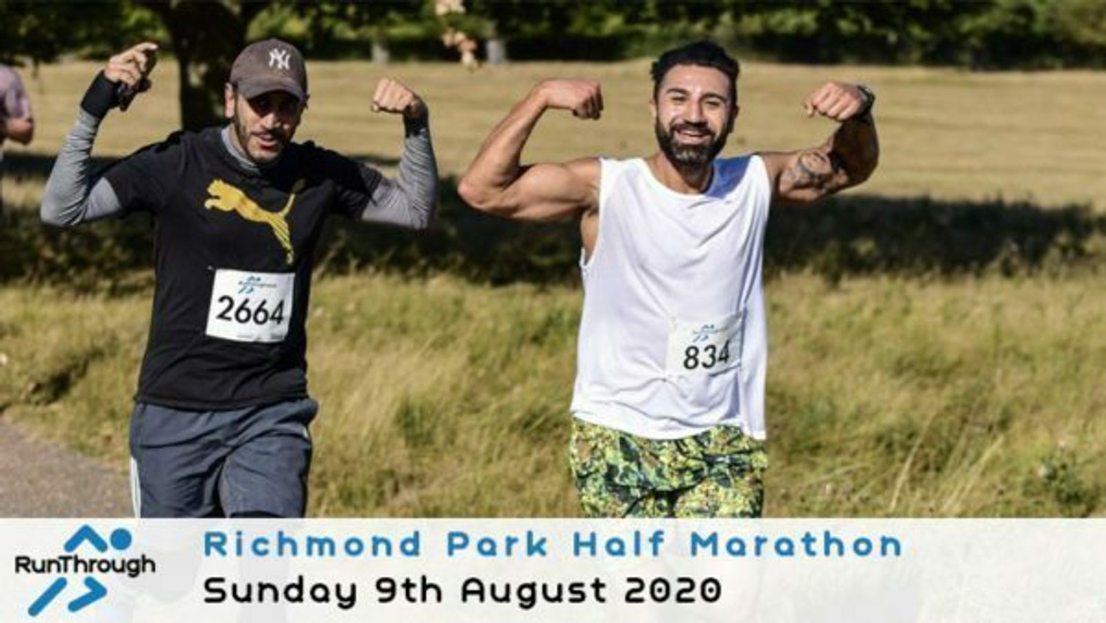Two men are running in a marathon. The man on the left wears a black cap, gray shirt, and dark pants. The man on the right, with a beard, wears a white tank top and patterned shorts, flexing his biceps. A text overlay at the bottom reads “Richmond Park Half Marathon, Sunday 9th August 2020.”.