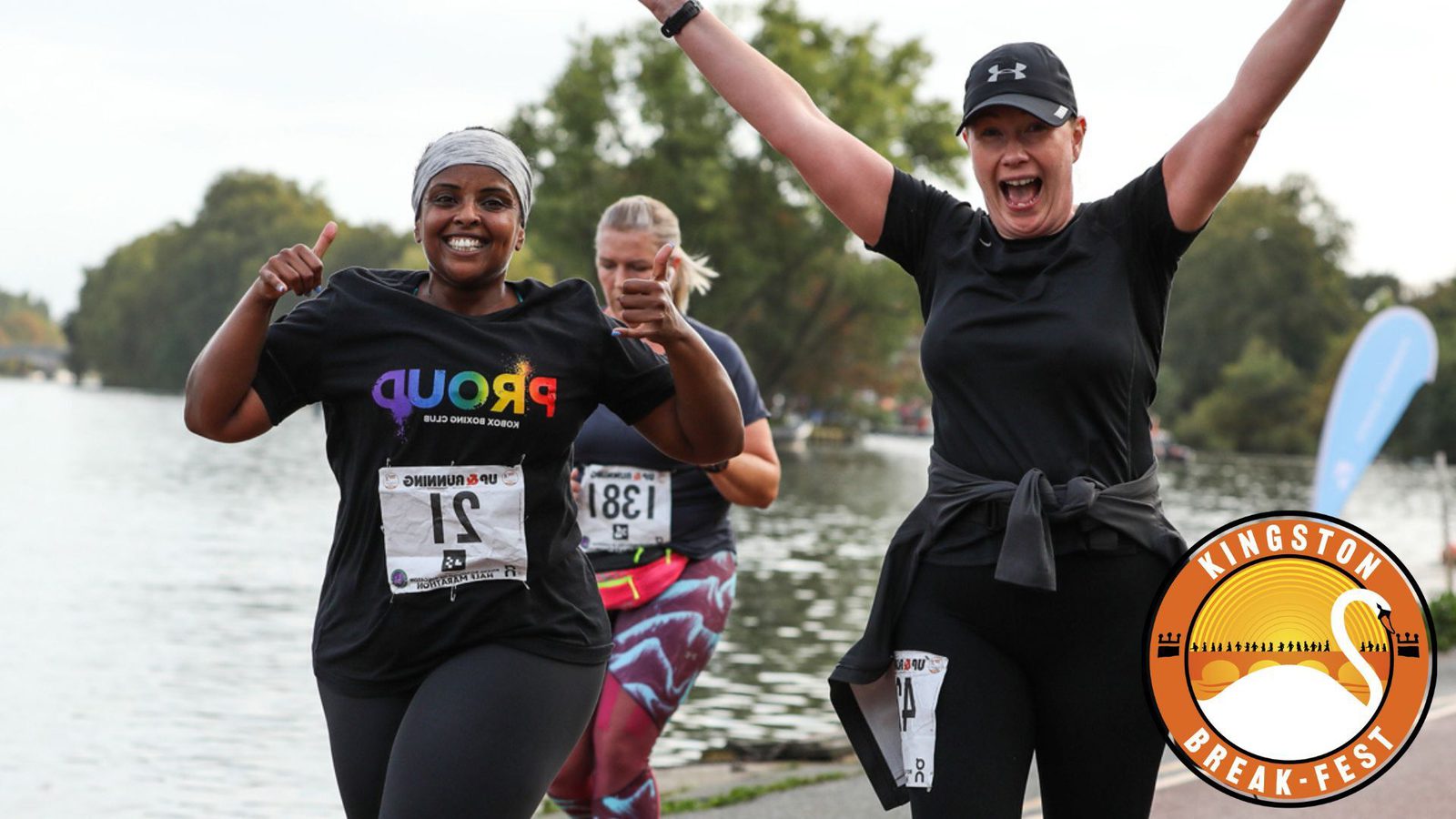 Two women are running outdoors beside water, smiling, and giving thumbs up and celebratory gestures. One wears a "Proud" shirt, the other a black cap. A third runner is behind them. The logo "Kingston Break-fest" featuring a sunrise is in the bottom right corner.