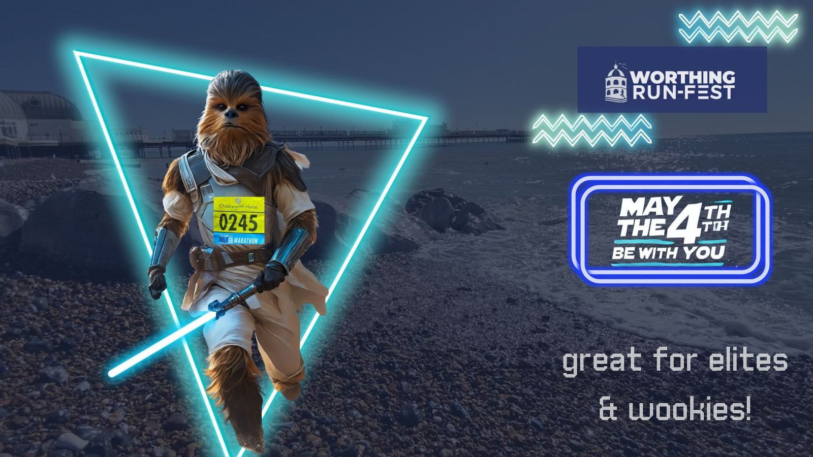 A person dressed as a Wookiee runs along a beach, holding a glowing blue lightsaber. Text reads "Worthing Run-Fest" and "May the 4th be with you." Another text says "great for elites & wookies!" Waves and piers are in the background.