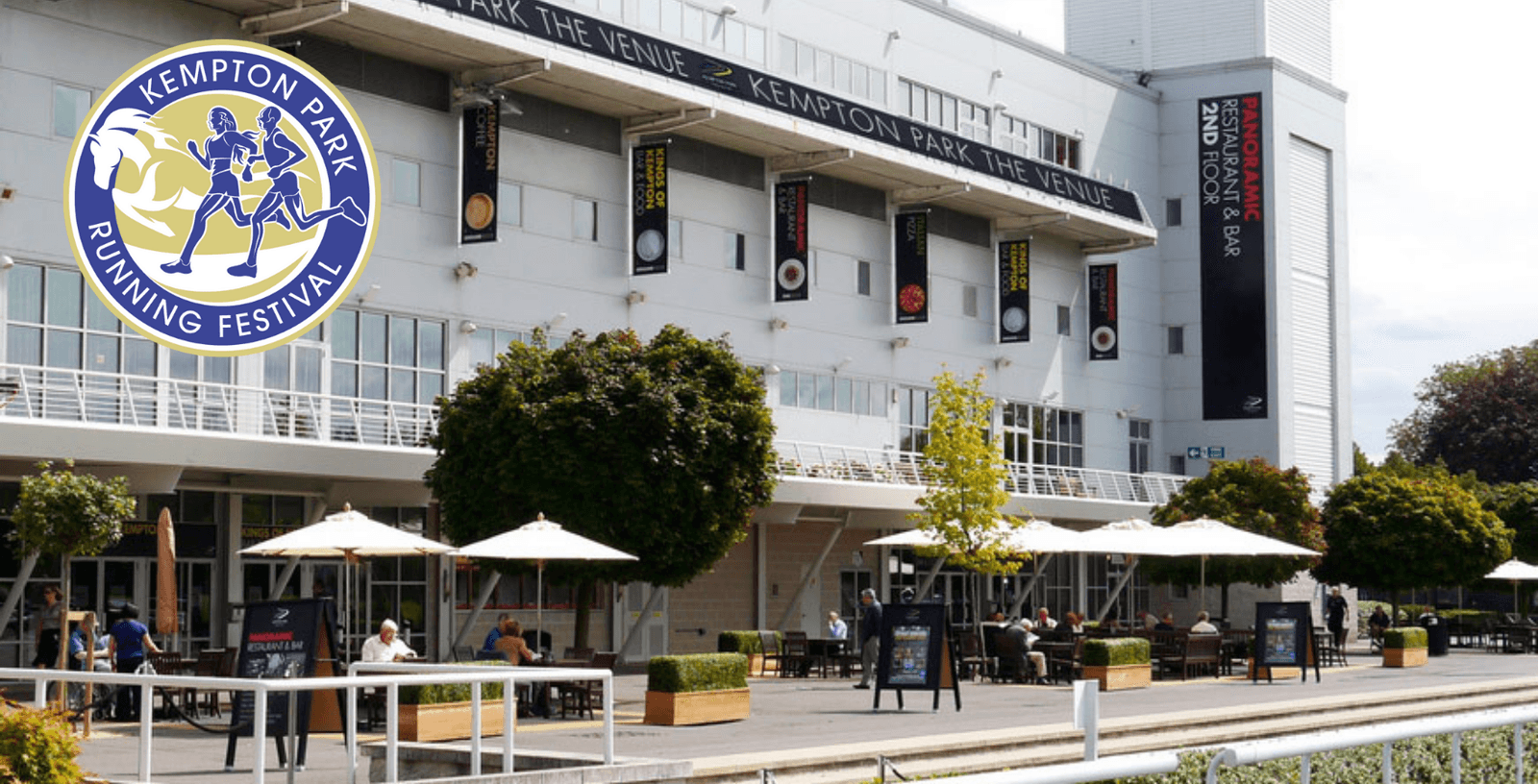 Outdoor seating area at Kempton Park, featuring tables with umbrellas and several people sitting and enjoying the space. The facade of a building with signage for “Kempton Park The Venue” is visible in the background. A "Kempton Park Running Festival" logo is superimposed.