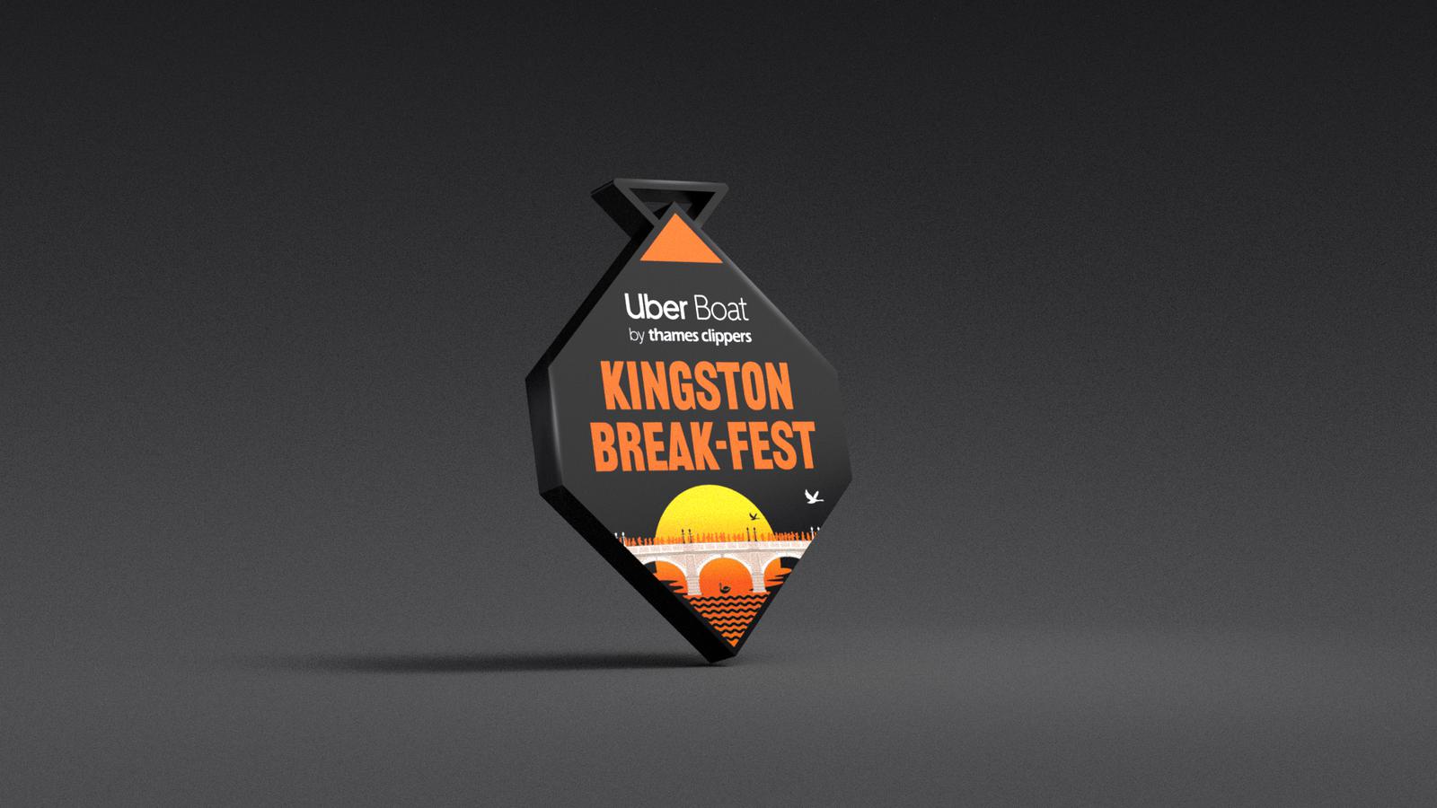 Orange and black badge with "Uber Boat by Thames Clippers" and "Kingston Break-Fest" text. Features a stylized sunrise design with a bridge and water. Badge is diamond-shaped with a stand.