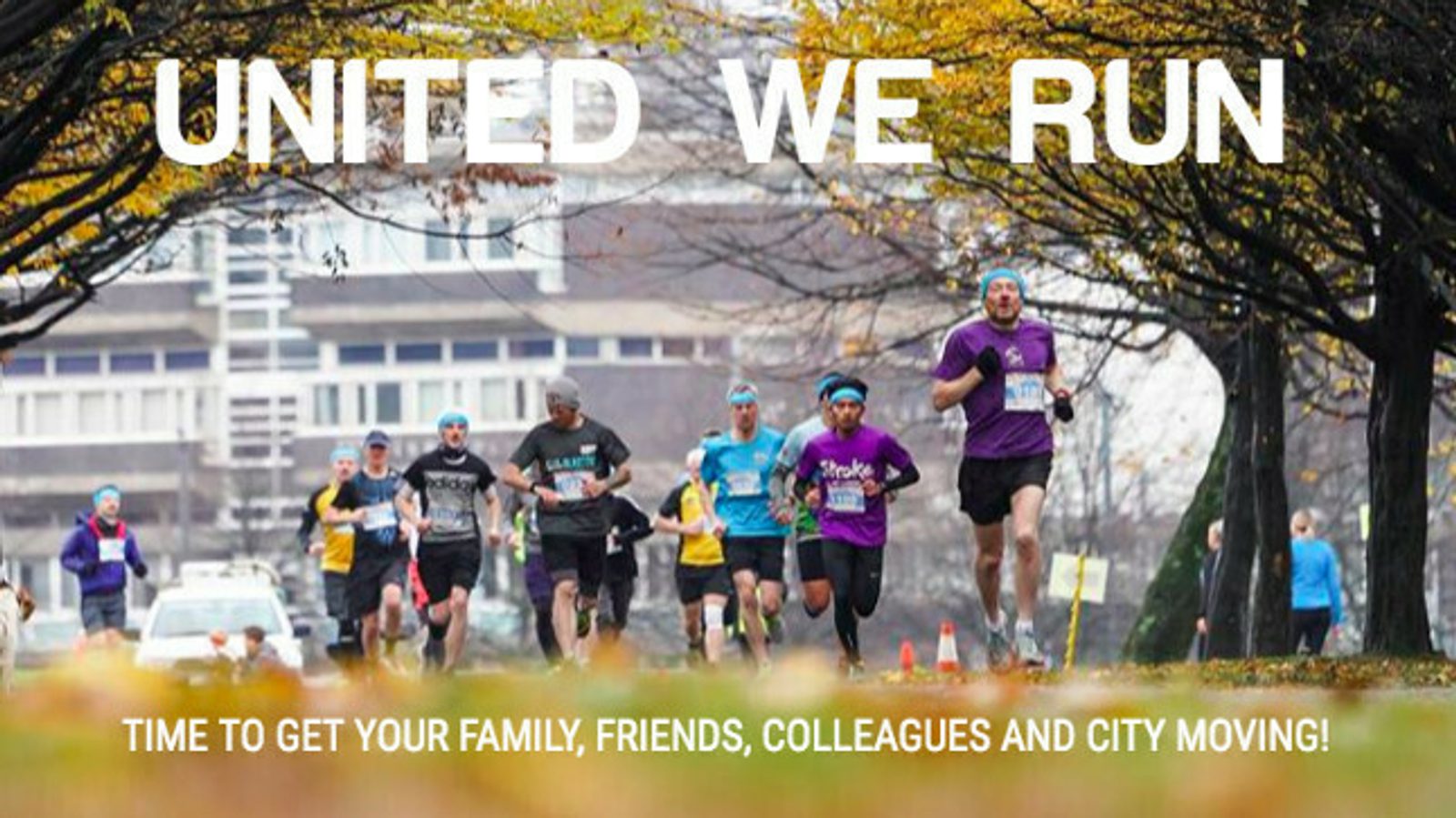 A group of runners is participating in a running event, moving down a tree-lined path during fall. The trees have yellow and orange leaves, and the ground is scattered with fallen leaves. The text at the top reads "UNITED WE RUN," and below, "TIME TO GET YOUR FAMILY, FRIENDS, COLLEAGUES AND CITY MOVING!.