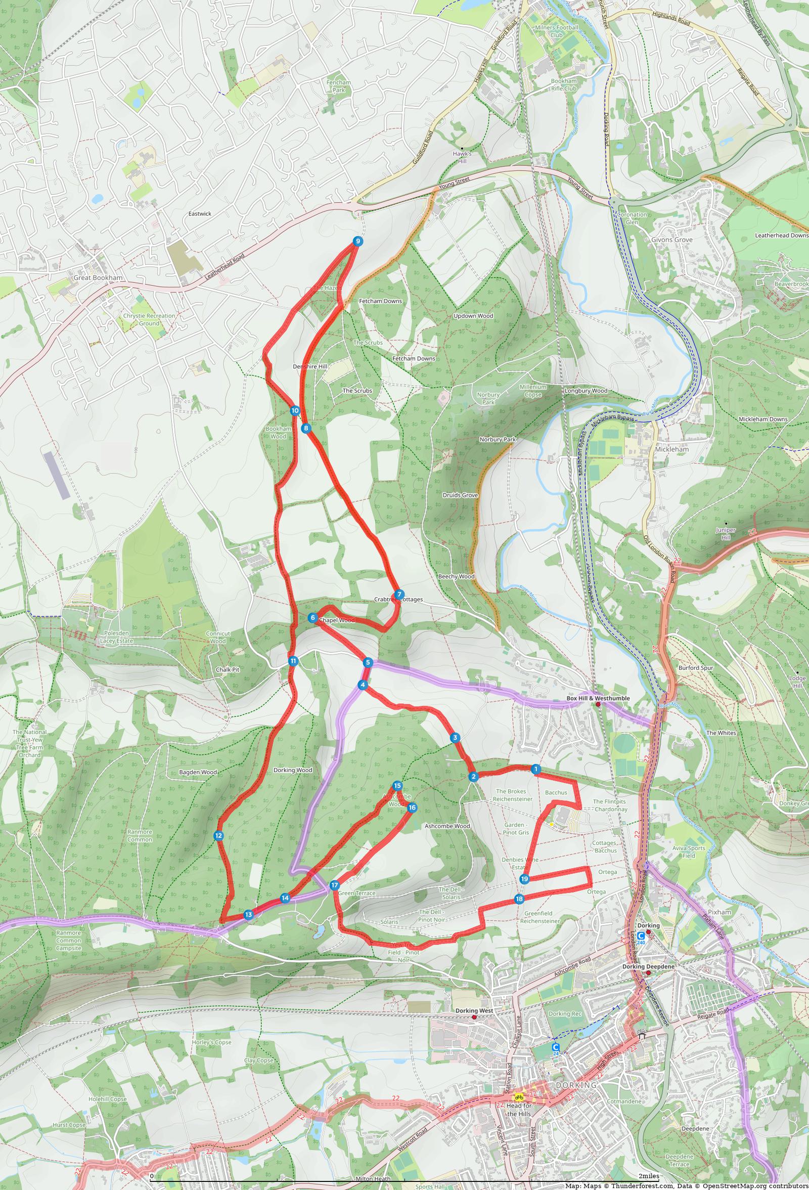 A detailed topographic map shows a walking route highlighted in red. The path weaves through green spaces, wooded areas, and partially through urban regions. Key points and intersections along the route are marked, indicating changes in direction and notable locations.