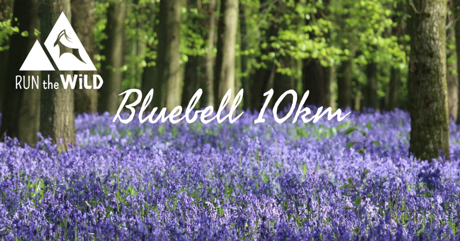 A picturesque forest scene with a carpet of blooming bluebell flowers. The words "RUN the WiLD Bluebell 10km" are overlaid on the image. Tall trees with fresh green leaves are visible in the background.