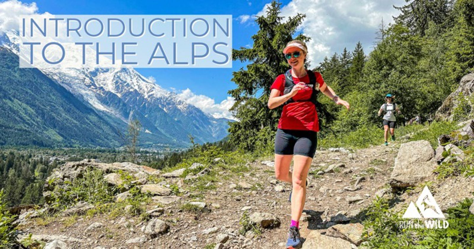 A woman in athletic gear runs on a rocky trail with a mountainous and forested landscape in the background under a bright blue sky. Another person is visible behind her. The text reads "Introduction to the Alps" and a "Run the Wild" logo is visible in the corner.