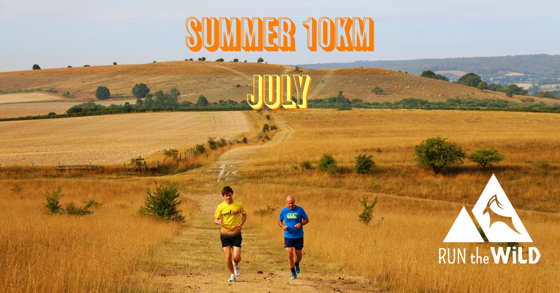 Two people are running on a trail through golden fields with hills in the background. The text "SUMMER 10KM JULY" is prominent at the top, and "RUN the WILD" with a mountain logo is at the bottom right. The scene is set on a sunny day with clear skies.
