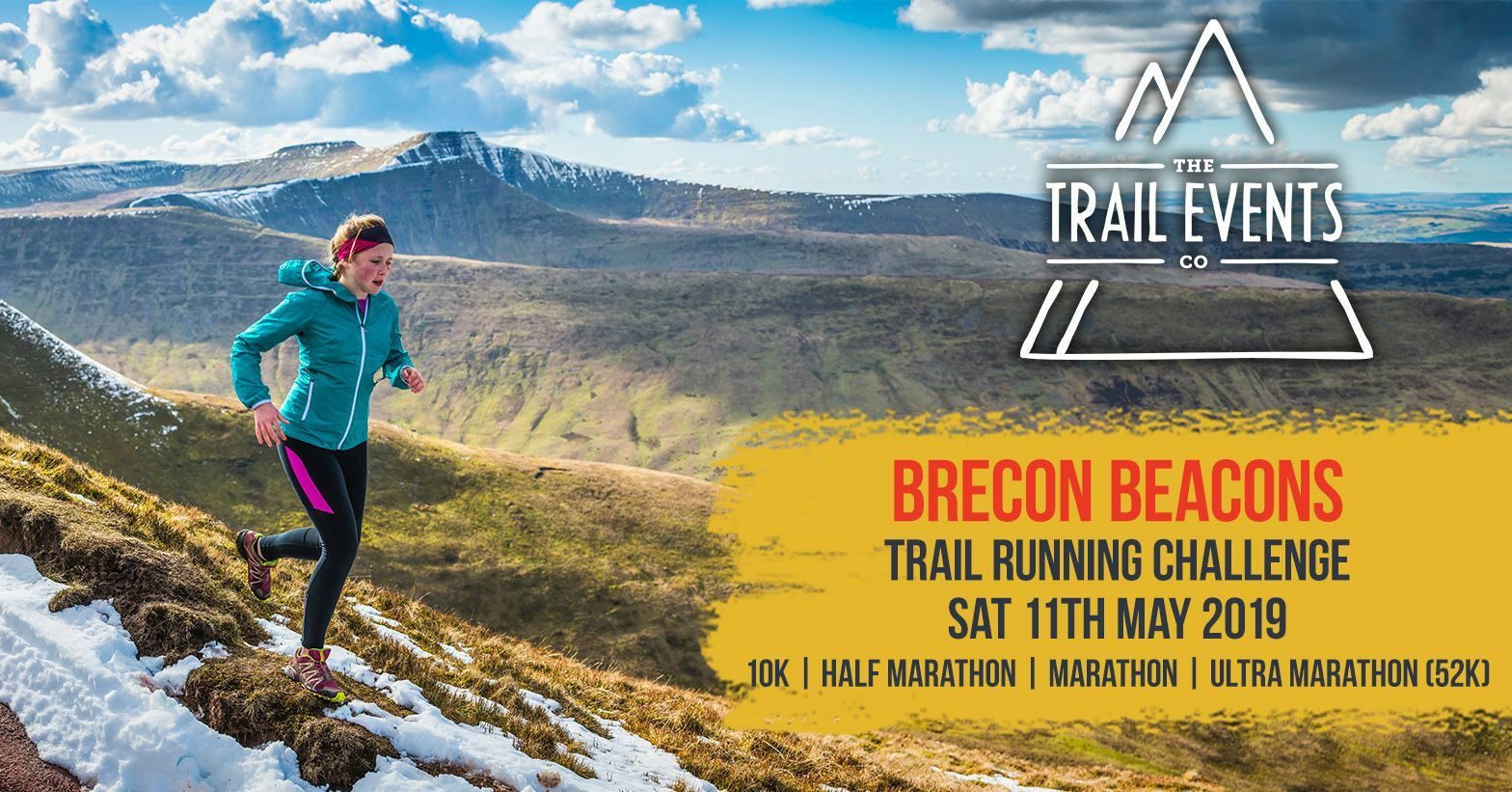 A woman runs along a snowy mountain trail under a blue, partly cloudy sky. Text reads: "Brecon Beacons. Trail Running Challenge. Sat 11th May 2019. 10K | Half Marathon | Marathon | Ultra Marathon (52K)." The Trail Events Co logo is visible in the top right corner.