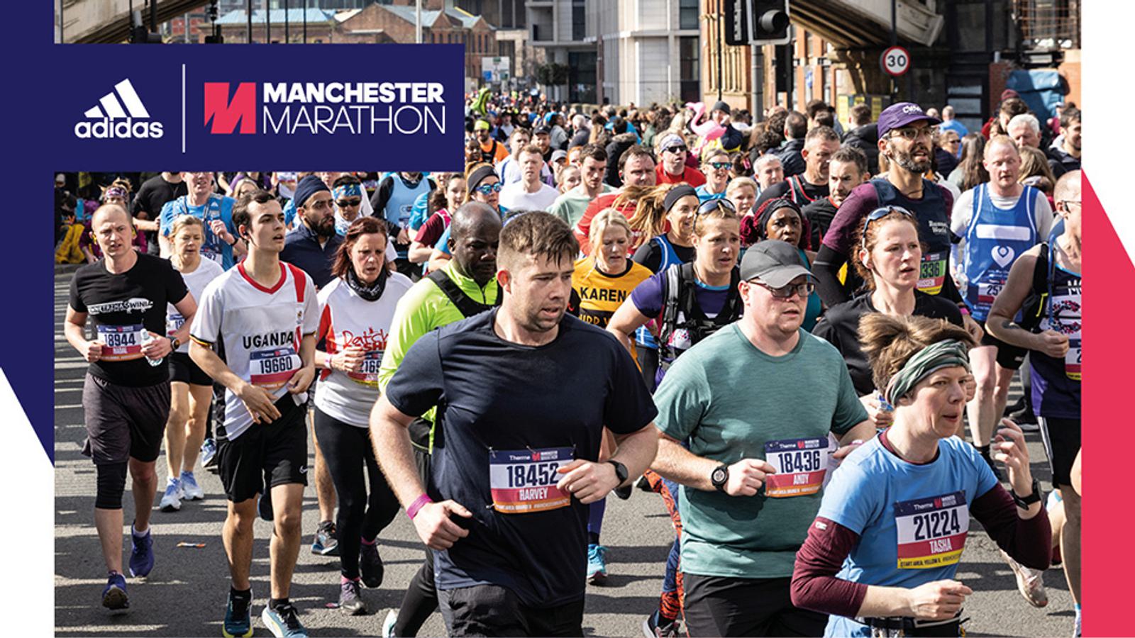 A large group of runners participating in the Manchester Marathon. The crowd is diverse, with people wearing various running attire. The Manchester Marathon banner and Adidas logo are visible in the top left corner of the image.