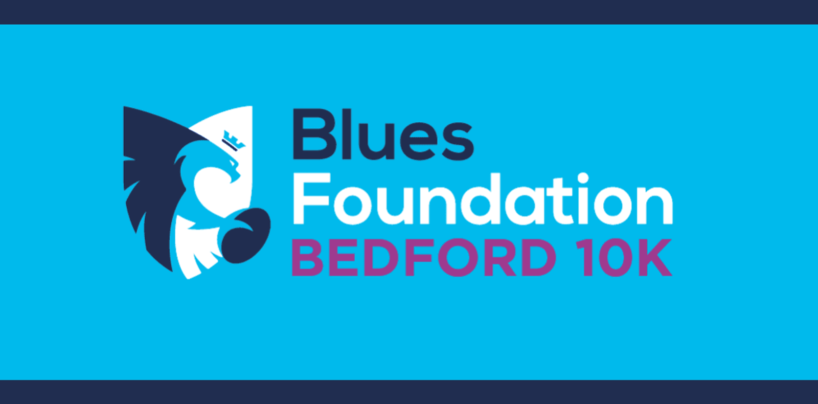 The image displays the logo for the "Blues Foundation Bedford 10K". It features a stylized lion's head in a shield on the left, followed by the event name. "Blues Foundation" is in black and white text, and "BEDFORD 10K" is in purple. The background is light blue.