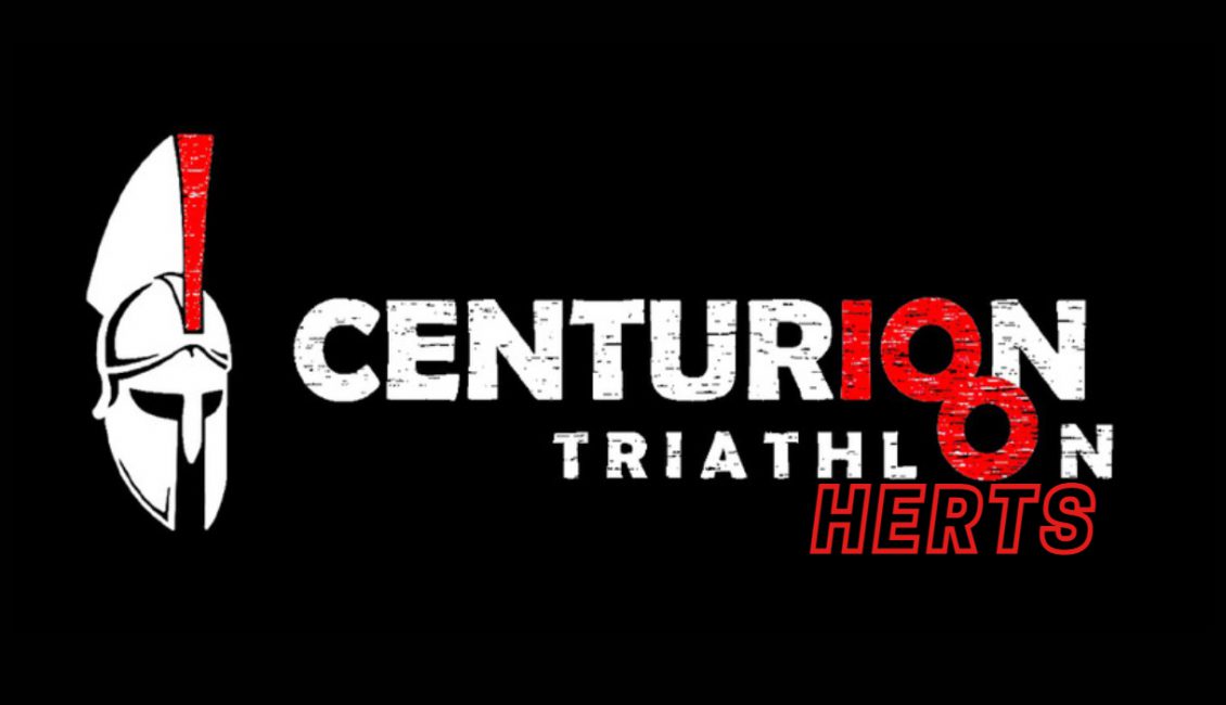 A logo with a black background features a white centurion helmet on the left and the words "Centurion Triathlon Herts" in bold text. "Centurion" is predominantly white with the letters "I" and "O" in red. "Herts" is written in red at the bottom right.
