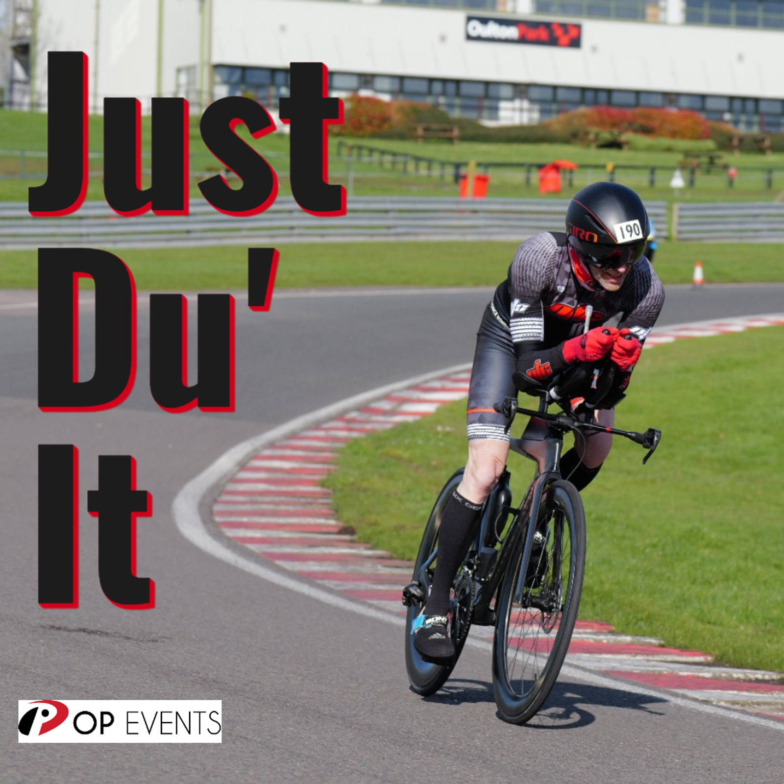 A cyclist wearing a helmet and racing gear rides a bike on a paved track. The text "Just Du' It" is written in bold on the left side. In the bottom left corner, there's a logo for OP Events. The background shows a building and greenery.