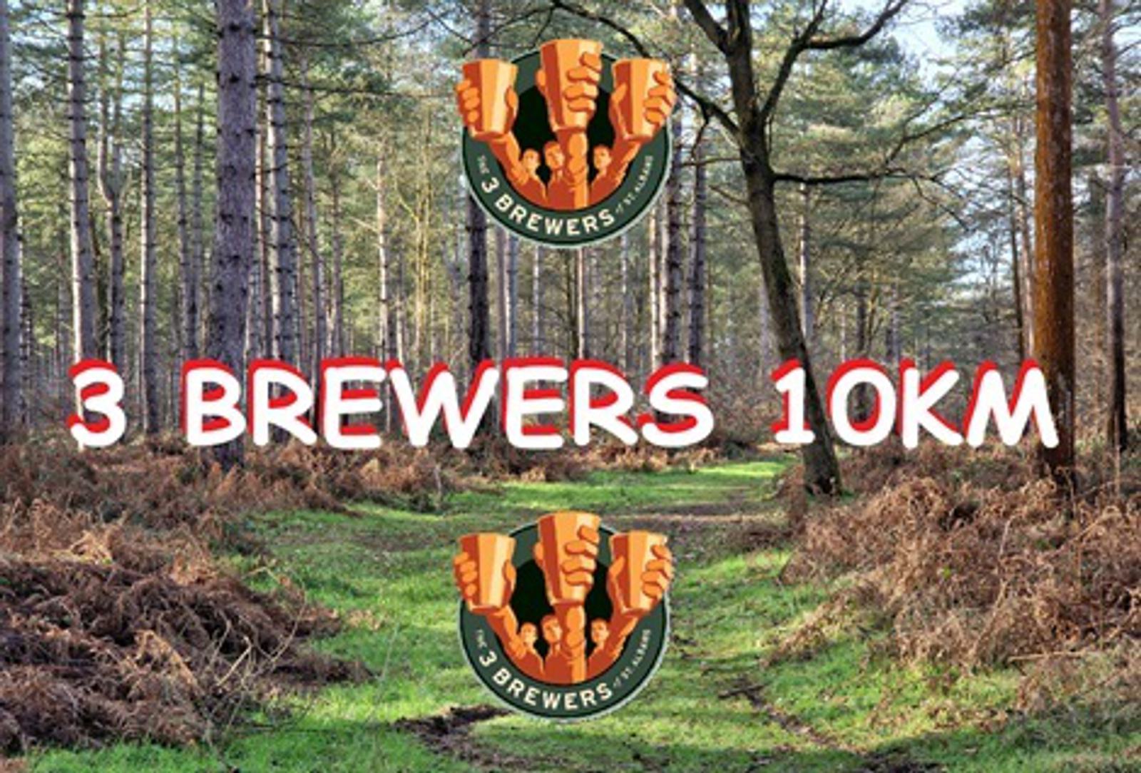 A forest trail in early spring with brown ferns and tall trees. Overlaid text reads "3 Brewers 10KM" with two logos featuring three beer mugs clinking together.