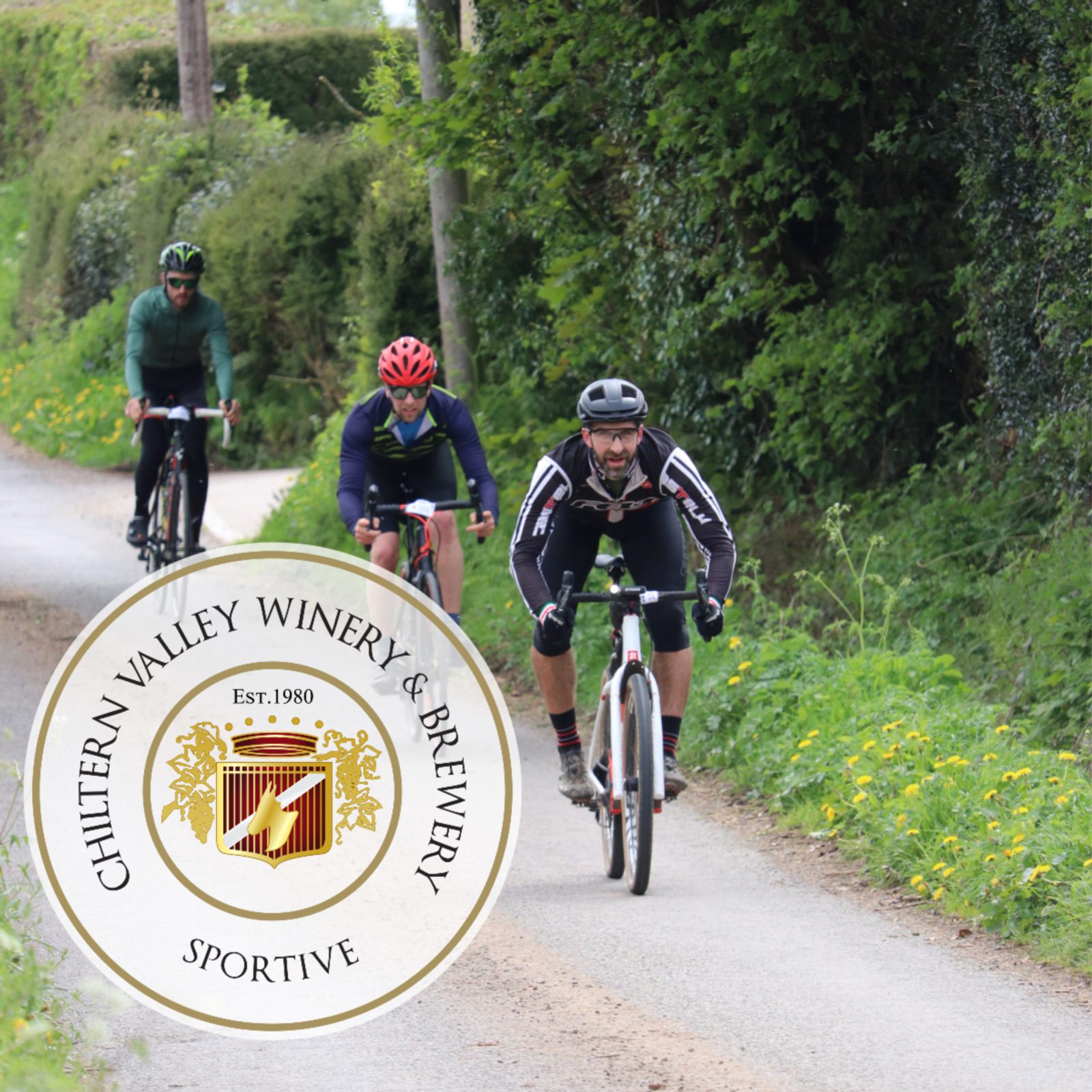 Three cyclists are riding along a narrow, tree-lined path. The cyclist in the lead wears a black and white outfit, the second cyclist wears a red helmet and blue jacket, and the third wears all green. A circular Chiltern Valley Winery & Brewery logo is overlaid on the image.
