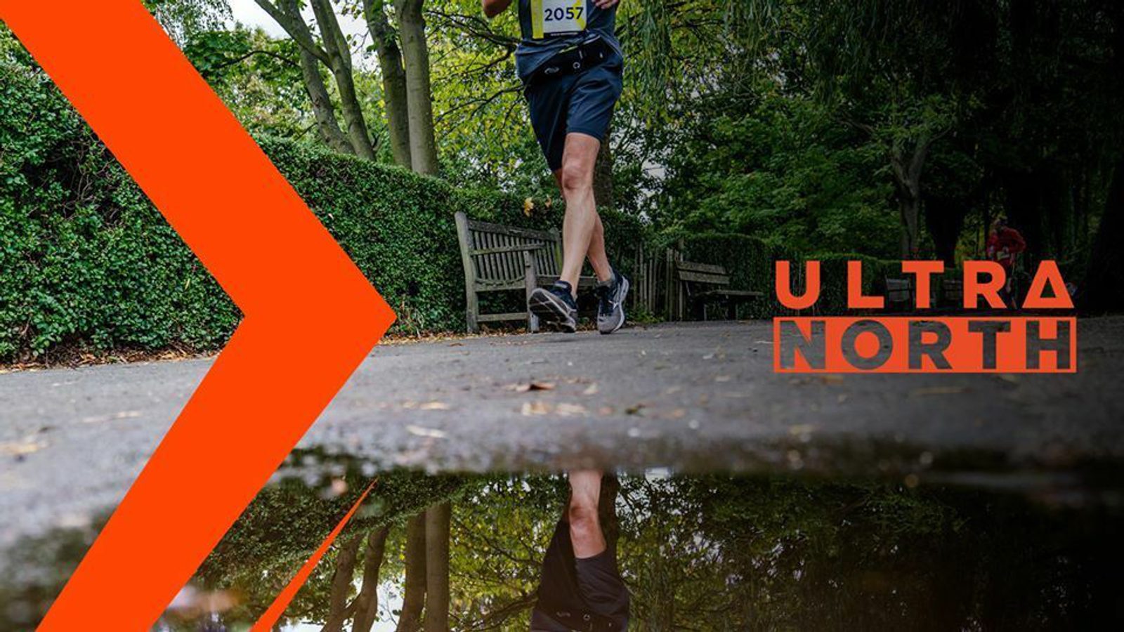 A lone runner is captured mid-stride on a tree-lined path, reflected in a puddle below. The event logo, "Ultra North," is displayed prominently on the right, while orange geometric graphics accent the scene on the left, contributing to a dynamic composition.
