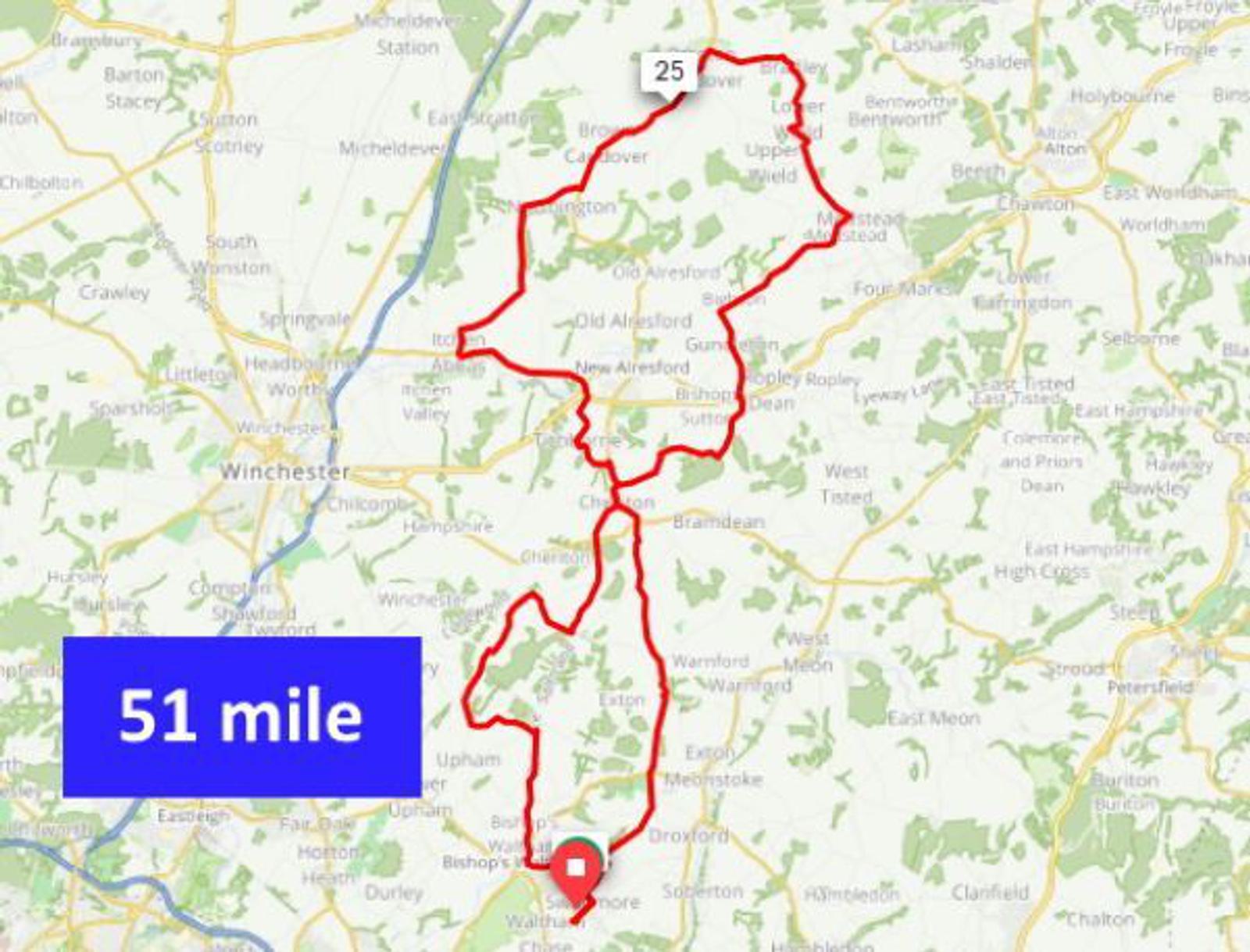 A map highlighting a 51-mile cycling route in red, winding through various towns and countryside areas. The route starts and ends at the same point, marked with labels suggesting directions or checkpoints, with a notable point labeled "25" approximately halfway.