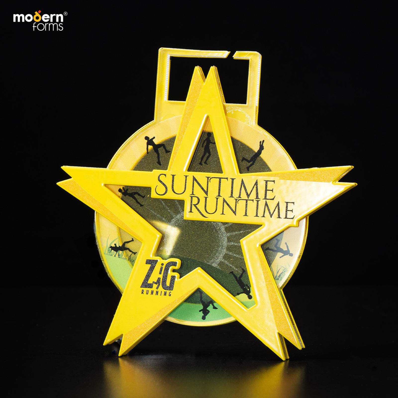 A star-shaped medal with the text "Suntime Runtime" on the front and "ZYG Running" at the bottom. The medal features a yellow star design and silhouettes of runners inside a circular background. The brand "modern forms" is in the top left corner.