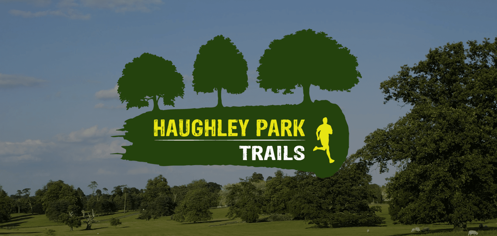 An outdoor scene with a logo featuring three tree silhouettes and a running person. The text reads "Haughley Park Trails." The background shows a park landscape with green fields, trees, and a clear blue sky.