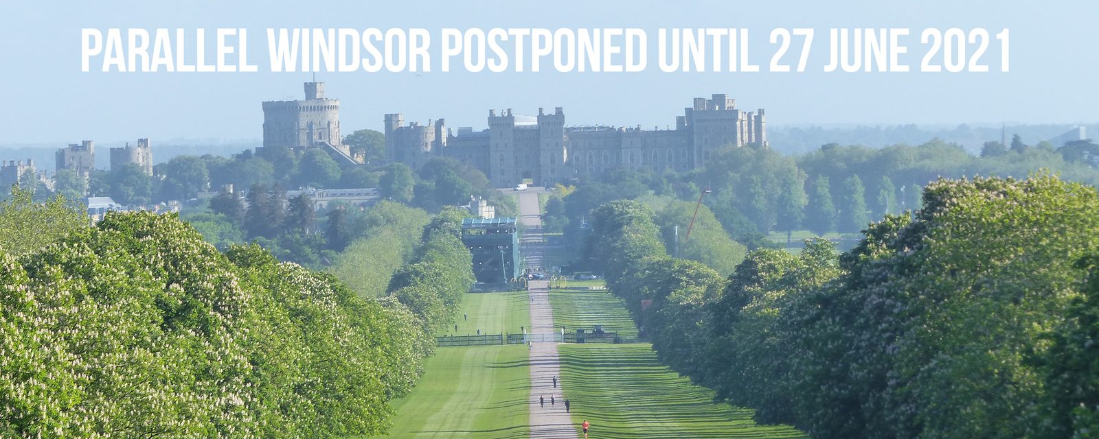 Image of Windsor Castle viewed from a distance down the Long Walk, a tree-lined path leading up to the castle. Text over the image reads: "PARALLEL WINDSOR POSTPONED UNTIL 27 JUNE 2021.