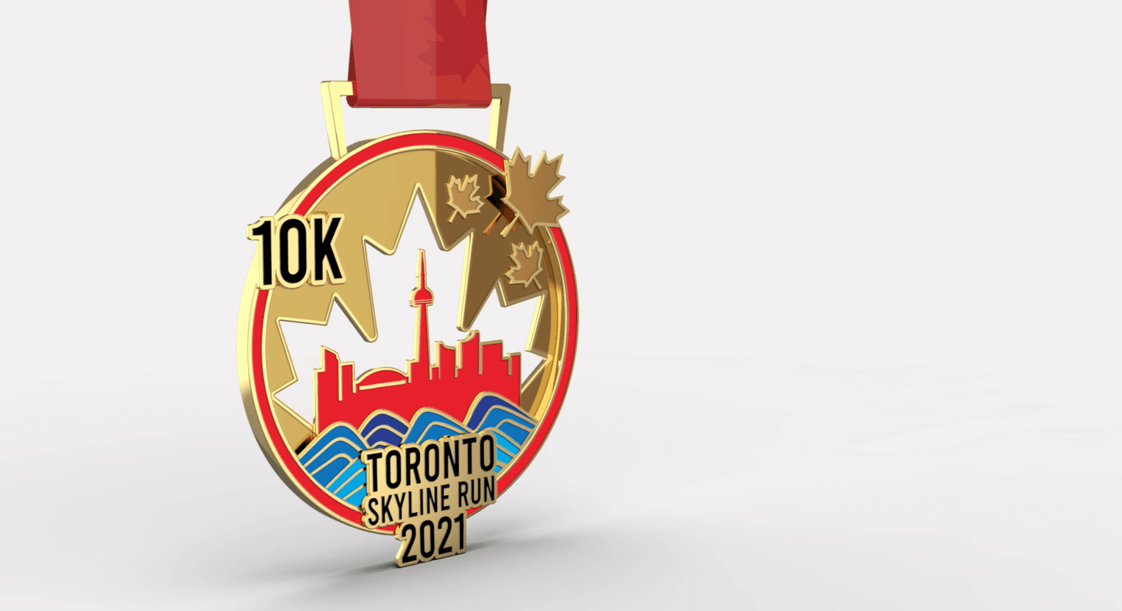 A gold medal with a red ribbon. The medal has the text "10K Toronto Skyline Run 2021" and showcases a red silhouette of Toronto's skyline against a white maple leaf. Two golden maple leaves adorn the side. Blue waves are depicted below the skyline.
