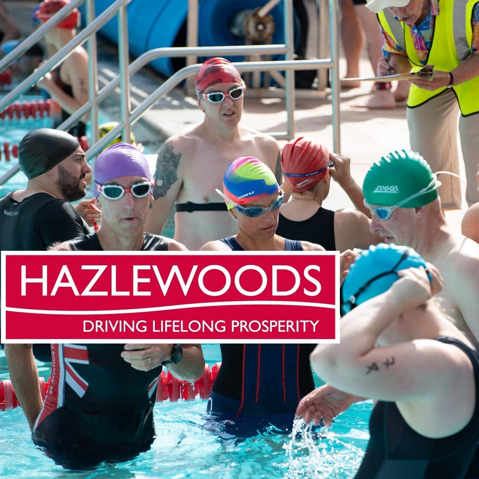 A group of swimmers, wearing various colored swim caps and goggles, gathers at the edge of a pool. They appear to be preparing for a competition or event. A lifeguard or official in a yellow vest is in the background. The image has a "Hazlewoods" logo overlay.
