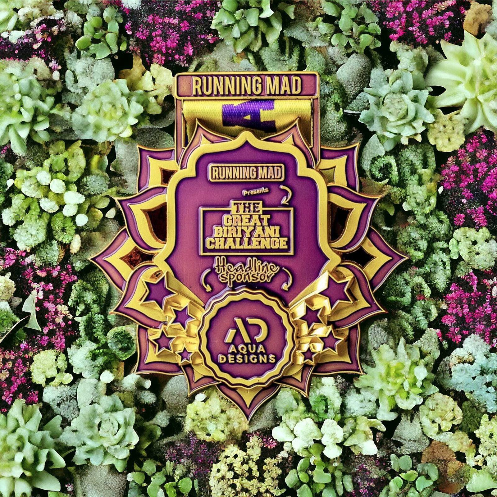 A vibrant medal with "Running Mad" and "The Great Britain Challenge" text, surrounded by a design of stars and floral patterns. The backdrop features a lush array of succulents.