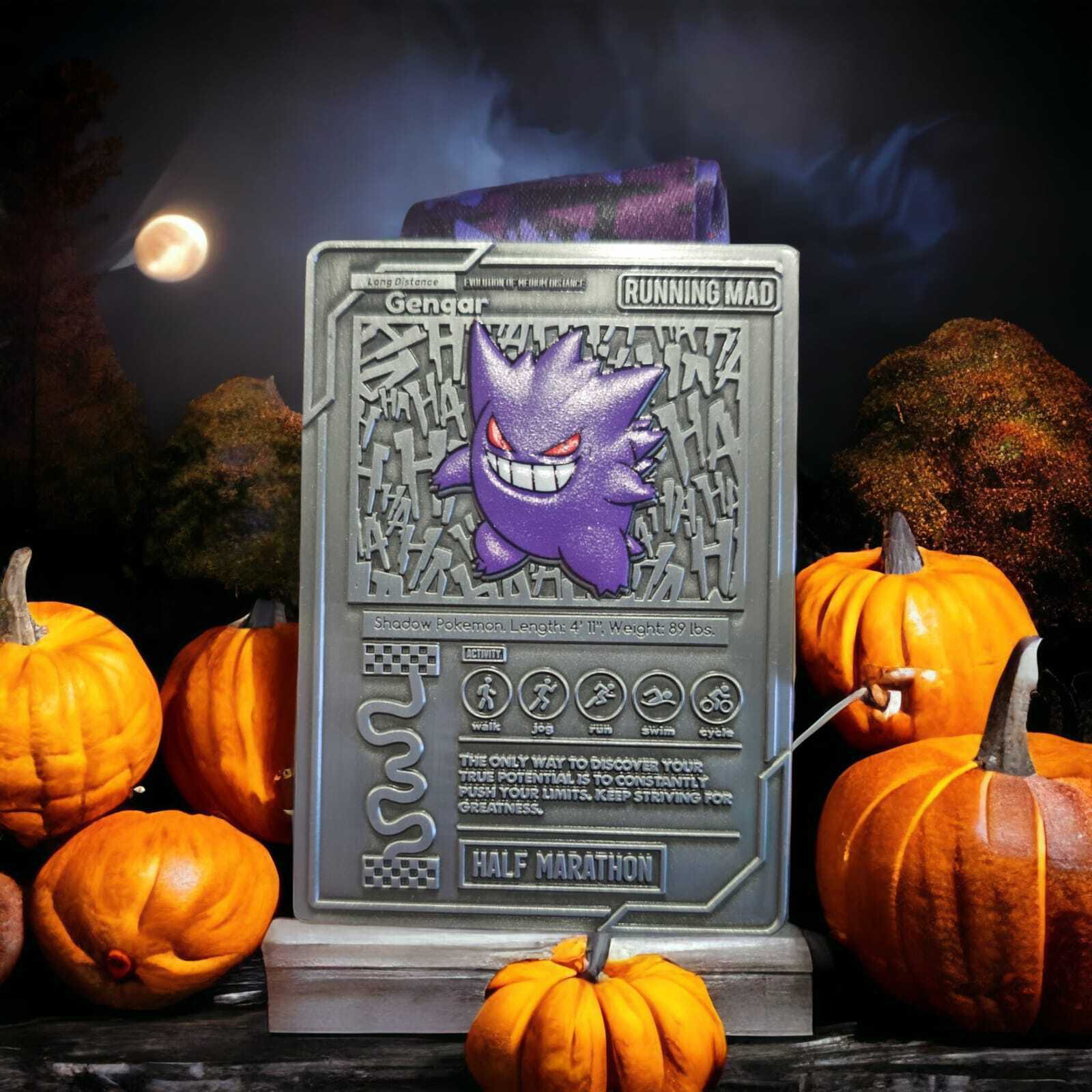 A silver running medal featuring a Gengar design is surrounded by small orange pumpkins. The backdrop includes a night sky with a full moon and dimly lit trees, creating a spooky atmosphere. The words "Running Mad" and "Half Marathon" are visible on the medal.