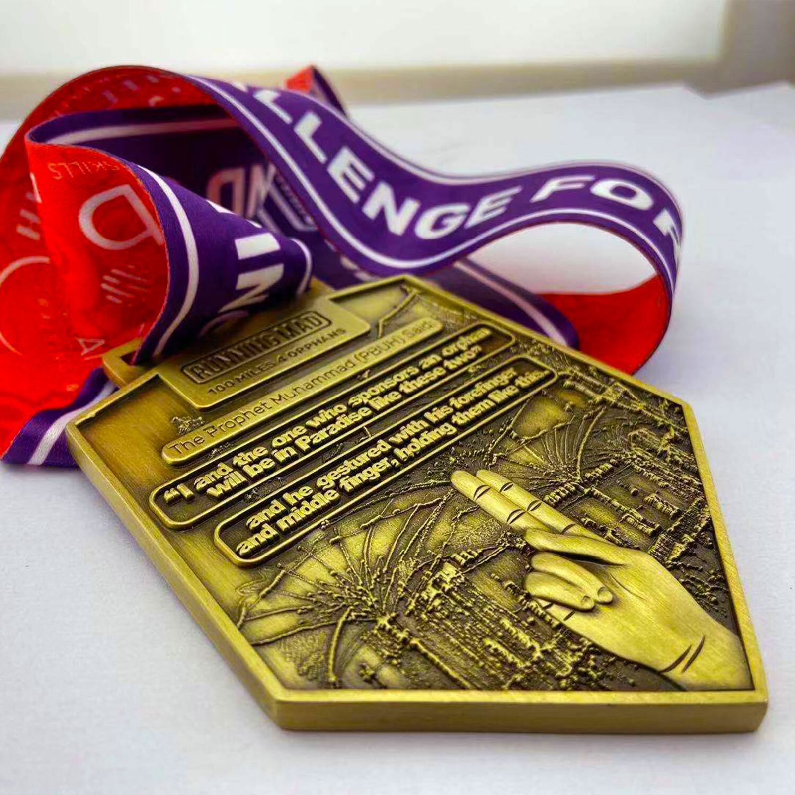 A gold medal with an embossed cityscape and a pointing hand. It hangs from a purple and red ribbon with text. The medal has engraved text honoring someone, though the details aren't fully visible. The setting is a neutral background.