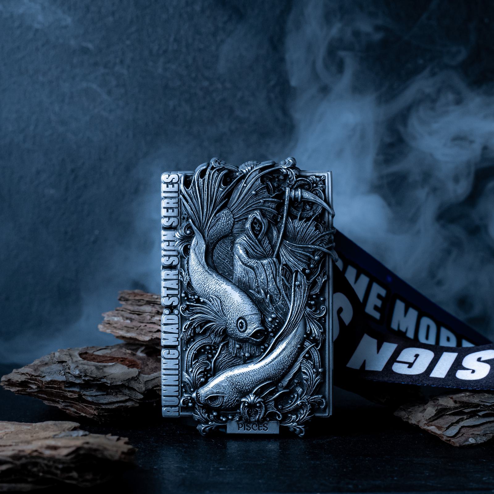 Ornate Pisces-themed object with artistic fish engravings sits on a dark surface. Smoke drifts in the background, creating a mystical atmosphere. Text reads "RUNNING AND STAR SIGNS SERIES" on the object. Pieces of bark are scattered nearby.