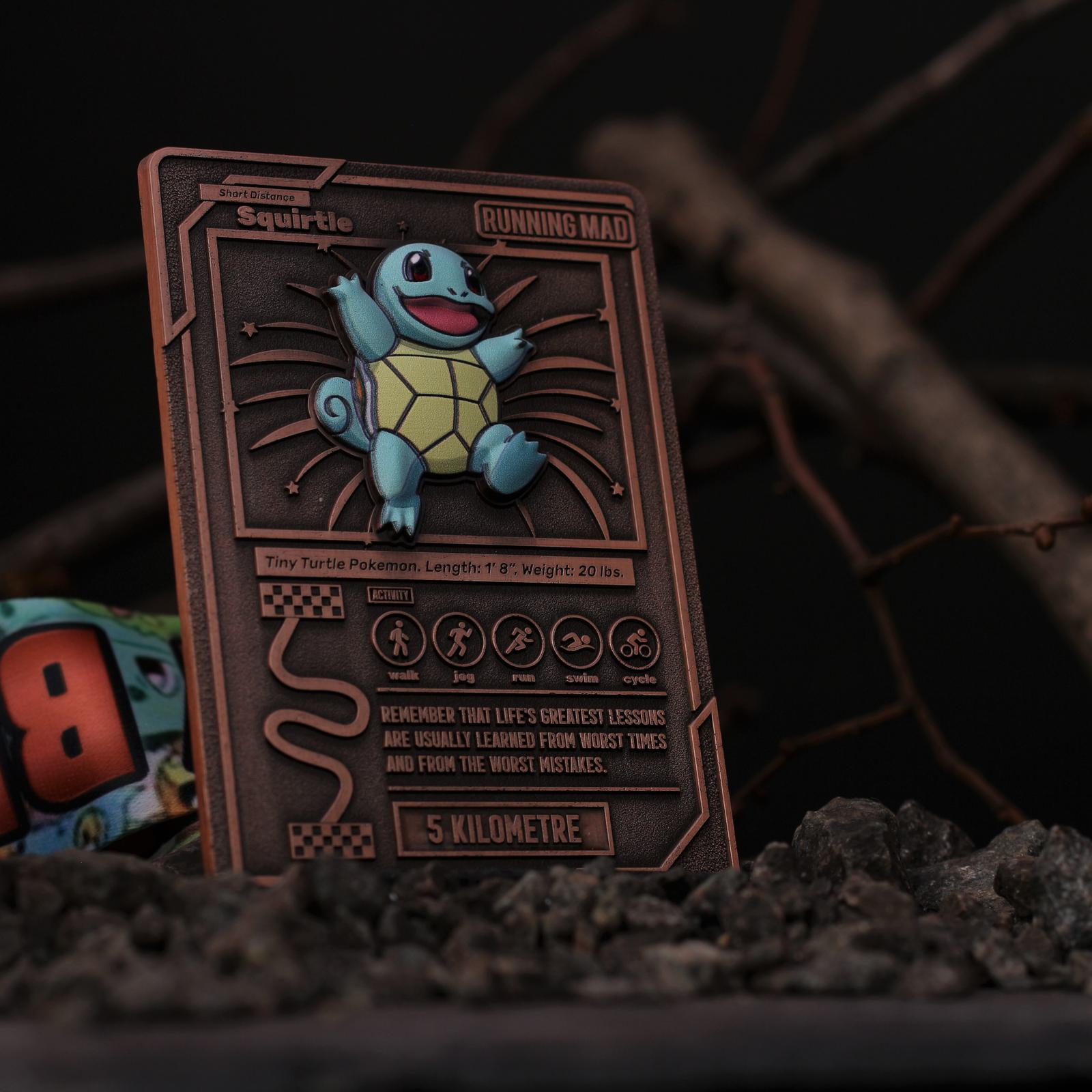 A custom Pokémon card featuring Squirtle with the text "Running Mad." The card has a rustic, engraved design and displays information like length, weight, and walking distance. It's standing on a rocky surface with a blurred background.