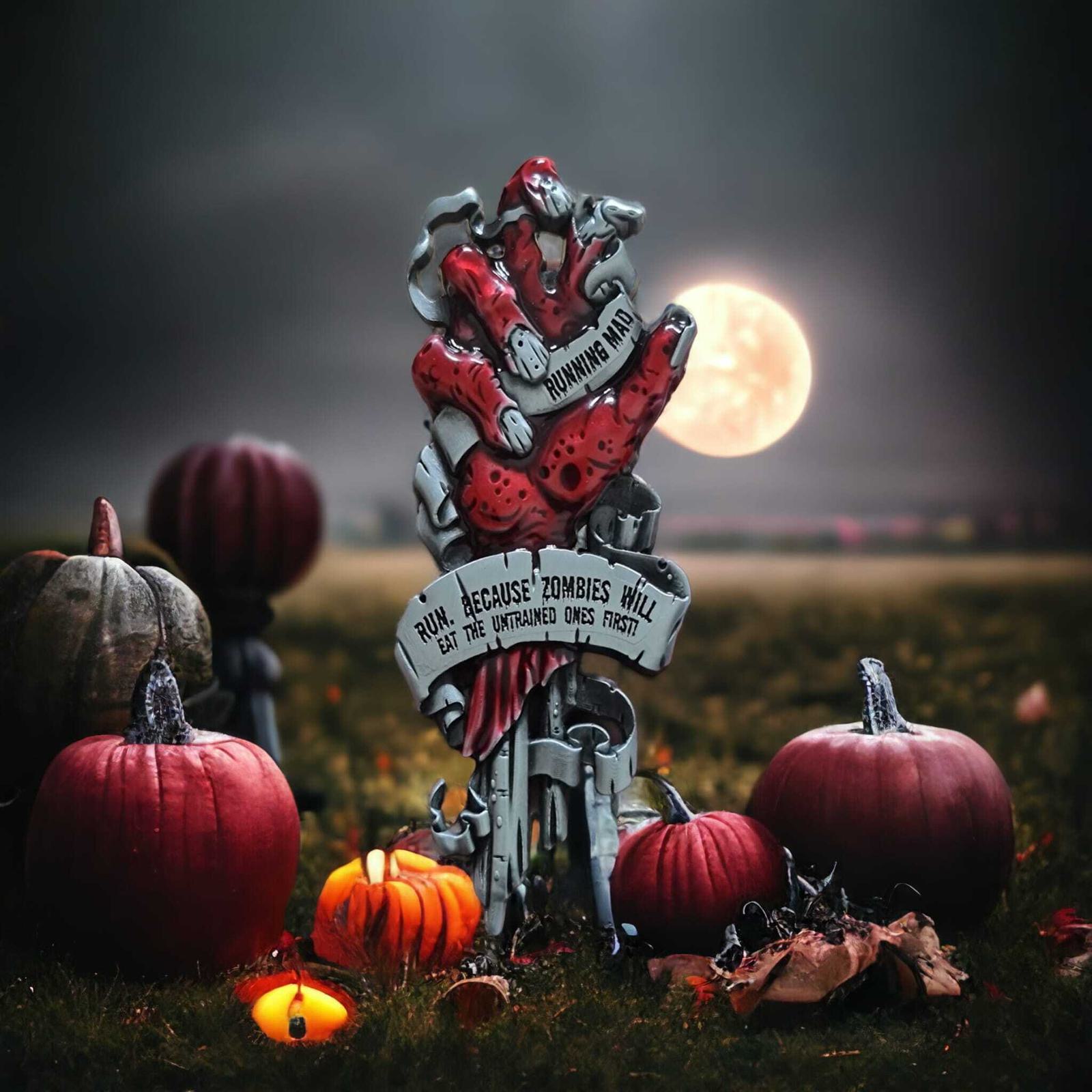 A creepy Halloween display features a hand emerging from the ground, surrounded by pumpkins under a full moon. The sign on the hand reads, "Run… because zombies will eat the untrained ones first." Candles add to the eerie atmosphere.