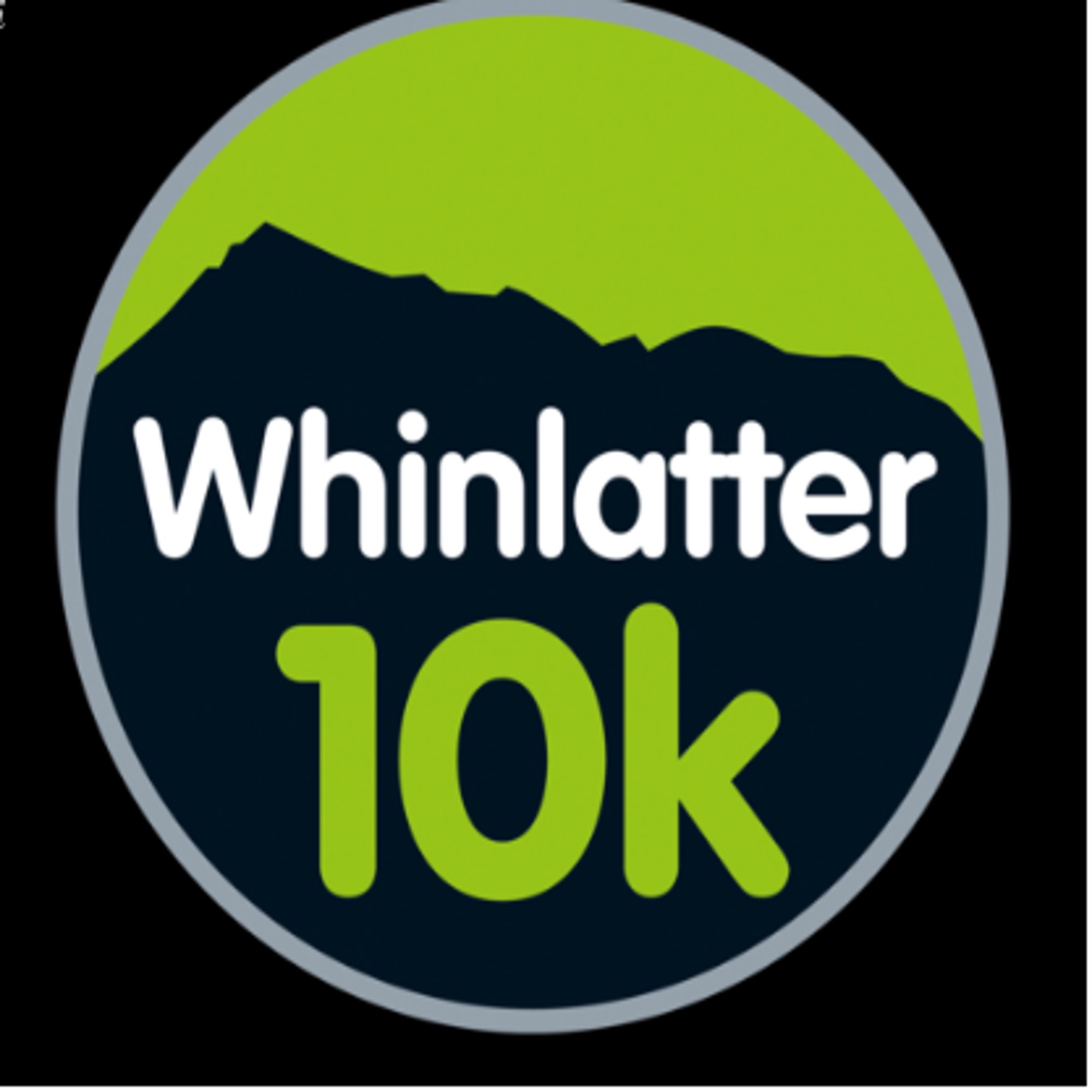 A circular logo with a black background and a green silhouette of a mountain at the top. The text "Whinlatter" is written in white and "10k" in green, both centered in the middle of the circle.