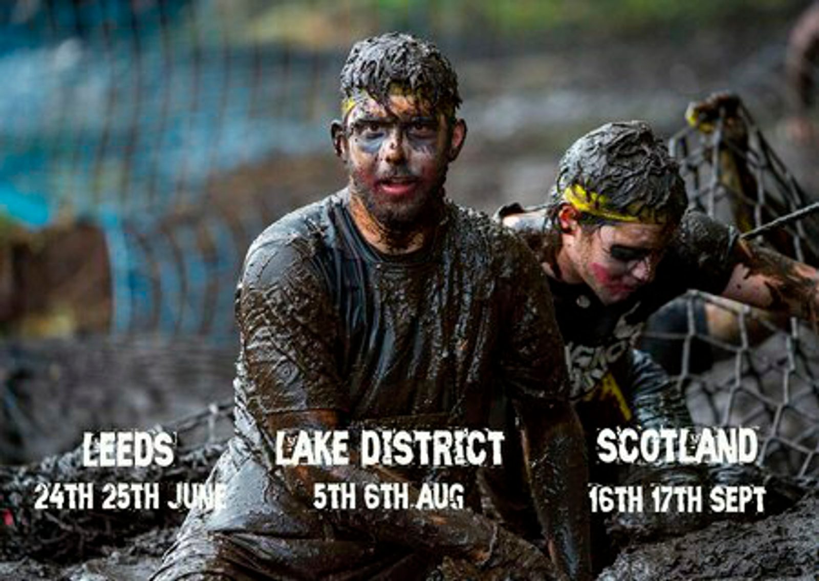 Two participants in a mud-covered obstacle race, both smeared with mud and wearing headbands, push through a netted section. Event dates and locations displayed: Leeds - 24th-25th June, Lake District - 5th-6th August, and Scotland - 16th-17th September.