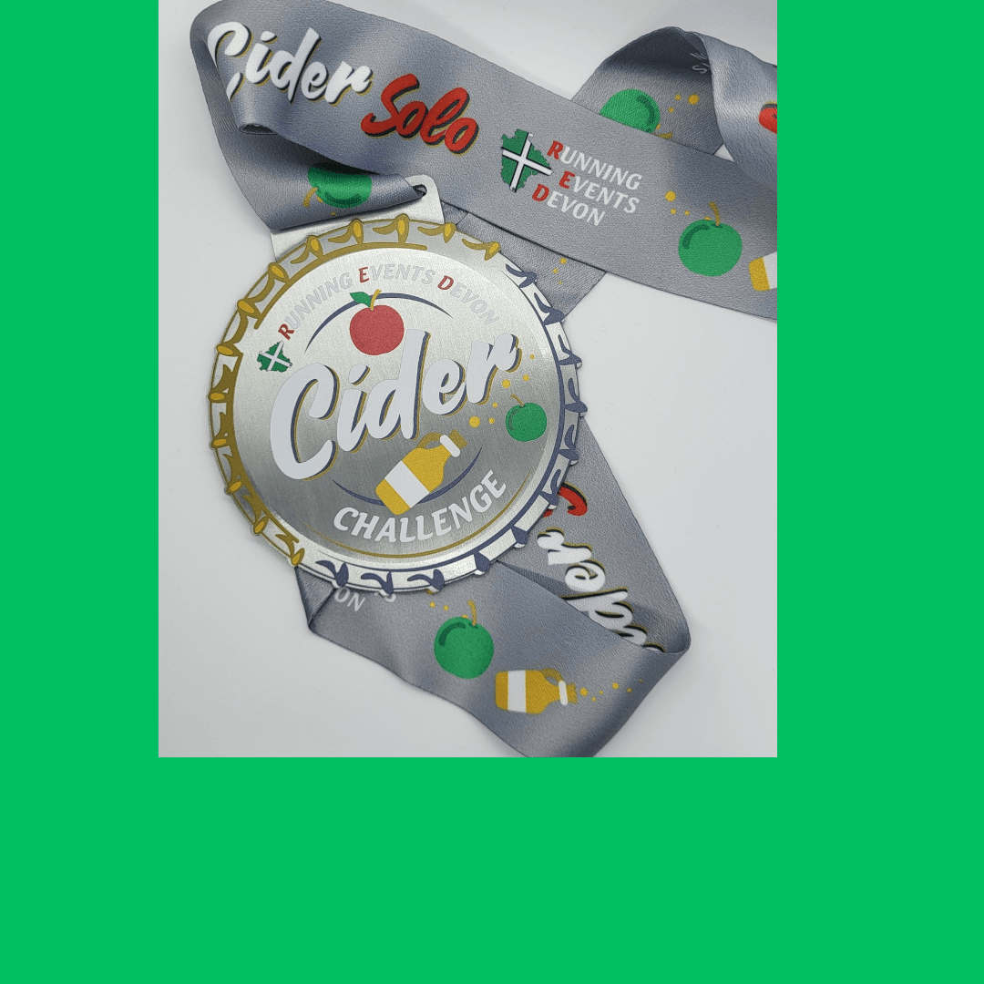A silver medal with the words "Cider Challenge" and images of apples and cider. The ribbon reads "Running Events Devon" and "Cider Solo," with apple and cider illustrations. The background is bright green.