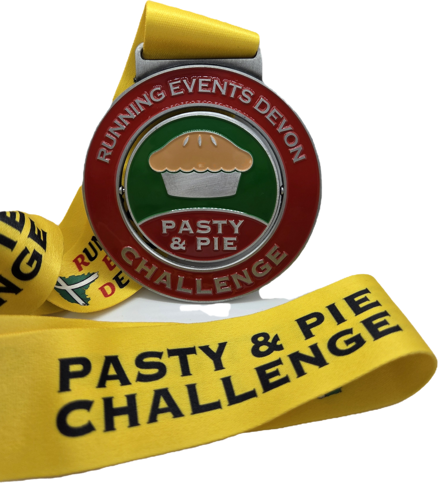A round medal with "Running Events Devon" and "Pasty & Pie Challenge" written on it, featuring an image of a pasty or pie. The medal hangs from a yellow ribbon reading "Pasty & Pie Challenge.