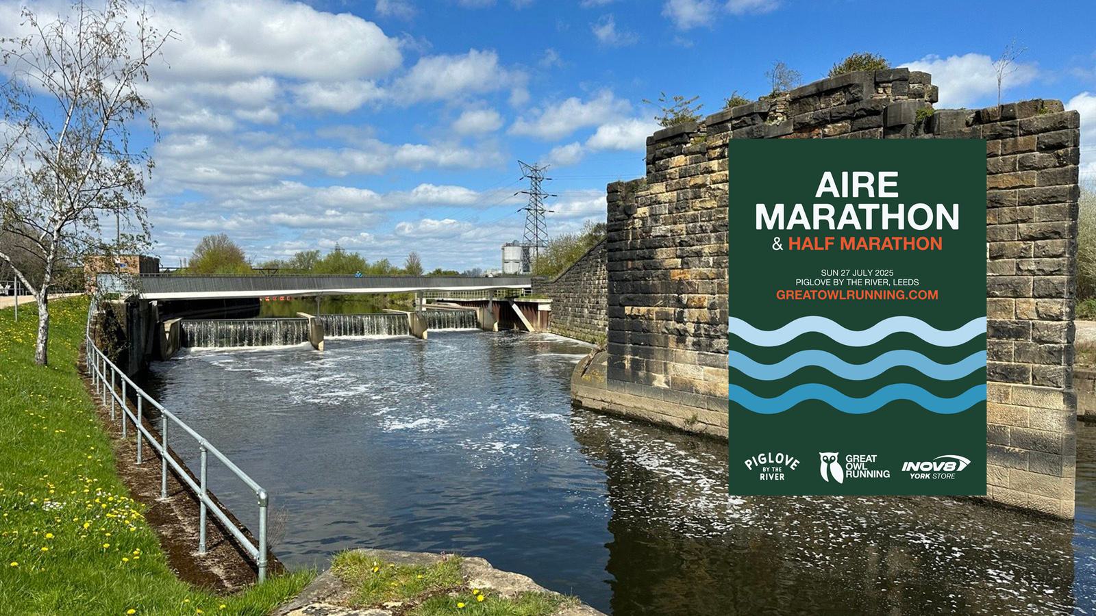 A scenic riverside view with a weir, greenery, and a walking path under a blue sky with clouds. A large poster promotes the Aire Marathon & Half Marathon with information on the event date and website.