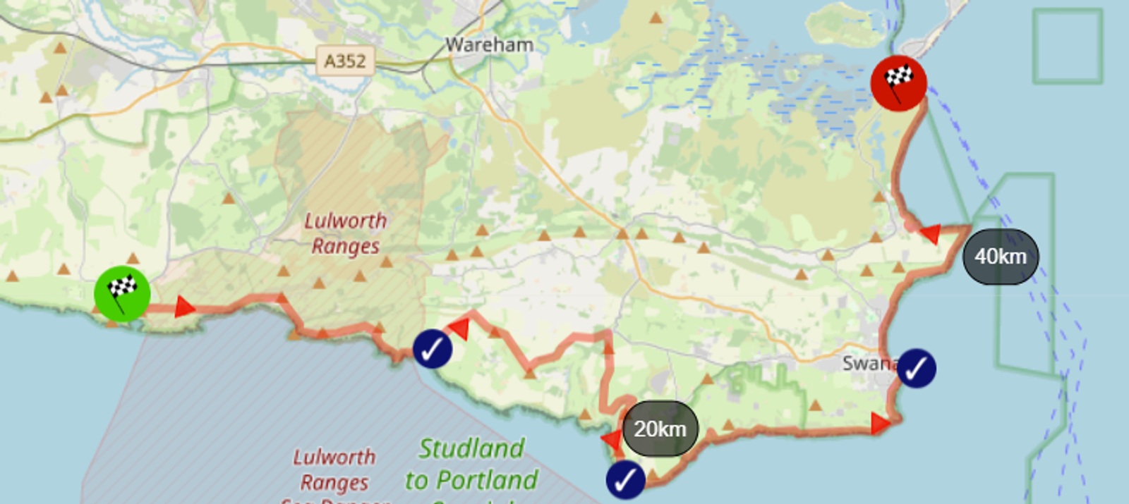 A map showing a coastal route from Studland to Lulworth. Waypoints are marked at 20km and 40km. The route begins in Studland, passes Swanage, and ends at Lulworth, with a path marked in red, paralleling the coastline.