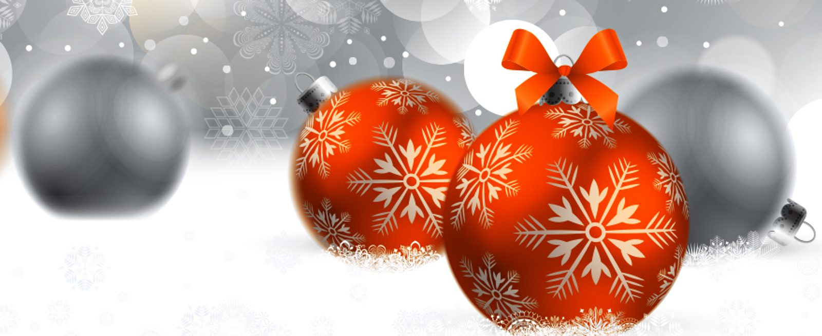 Three red Christmas ornaments with white snowflake patterns are in the foreground, one with a red bow. Two blurred silver ornaments are in the background, with snowflakes and bokeh lights creating a festive winter scene.