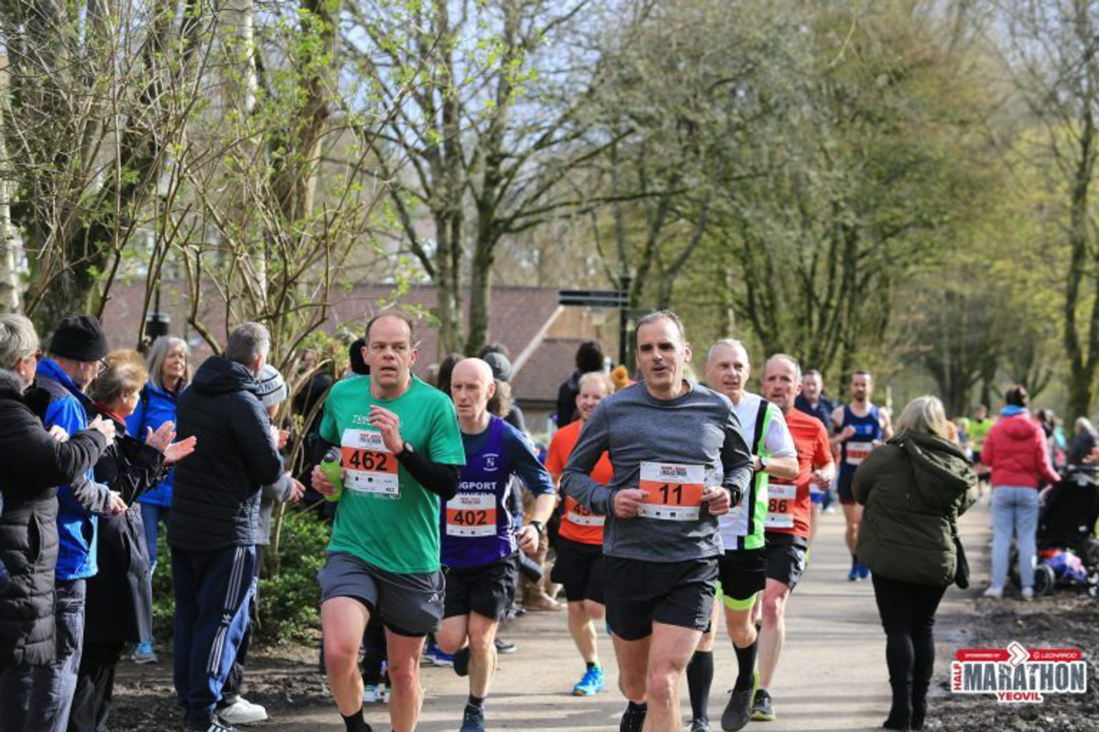 A group of people running on a road.