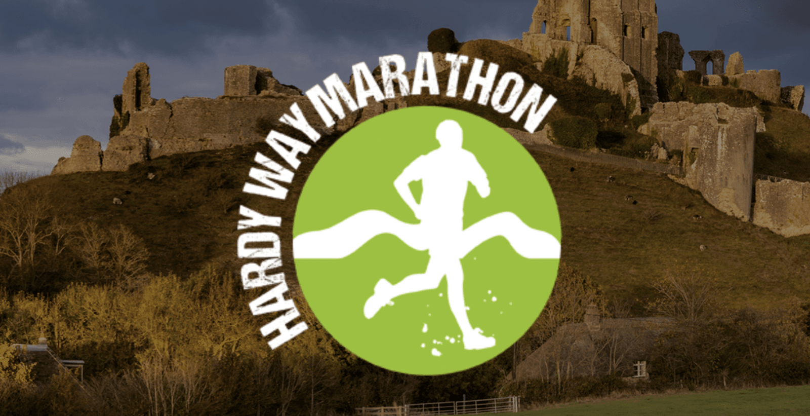 A logo reading "HARDY WAY MARATHON" encircles a white silhouette of a runner on a green background. The runner is approaching a finish line ribbon. In the backdrop, there's a scenic view of ancient ruins situated on a hill with a cloudy sky overhead.